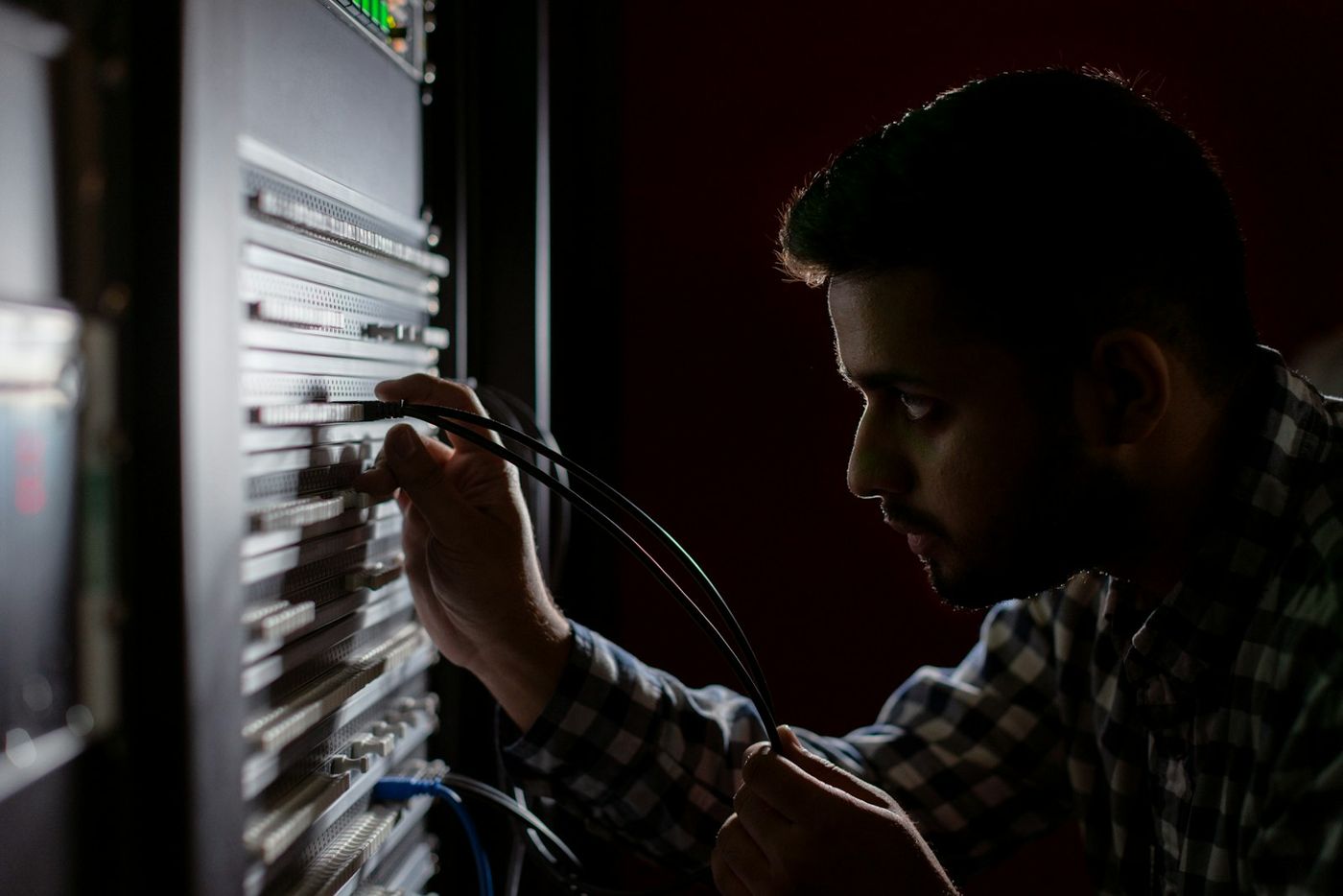 Probe India network engineer patching cables on a server rack